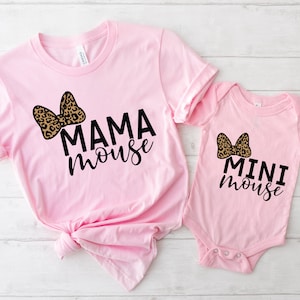 May include: Pink t-shirt with a leopard print bow and the text "MAMA mouse" and a pink bodysuit with a leopard print bow and the text "MINI mouse".