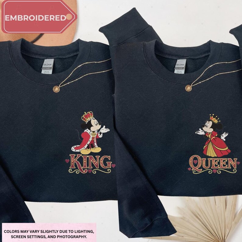 two black sweatshirts with the Disney characters Mickey Mouse and Minnie Mouse, each with a crown and the text "King" and "Queen" printed on them.