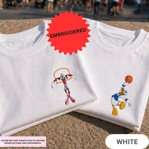two white t-shirts with cartoon basketball players printed on them.