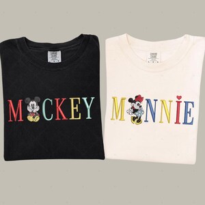 two t-shirts with the word "MACKKEY" printed on them, along with the character Minnie Mouse.