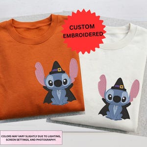 two t-shirts with a character design, one orange and one white, both with a witch-like motif.