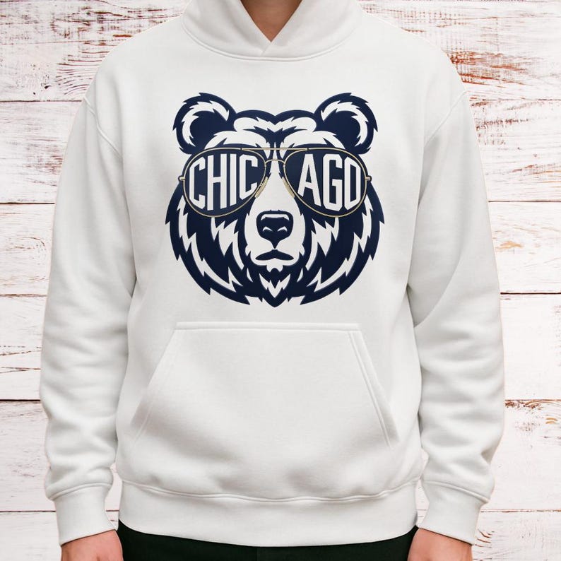 A white hoodie with a graphic design of a bear wearing sunglasses and the text "CHICAGO" printed on it.