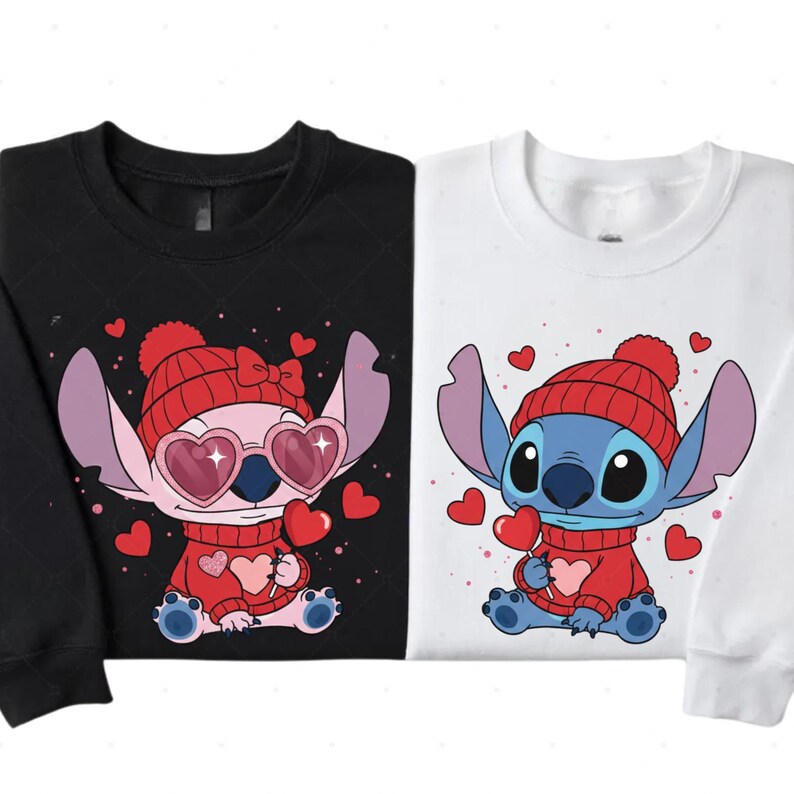 two t-shirts with a cartoon character design, specifically a pink character with a bow and red pom-pom hat, and a blue character with a red hat and heart-shaped pom-pom.