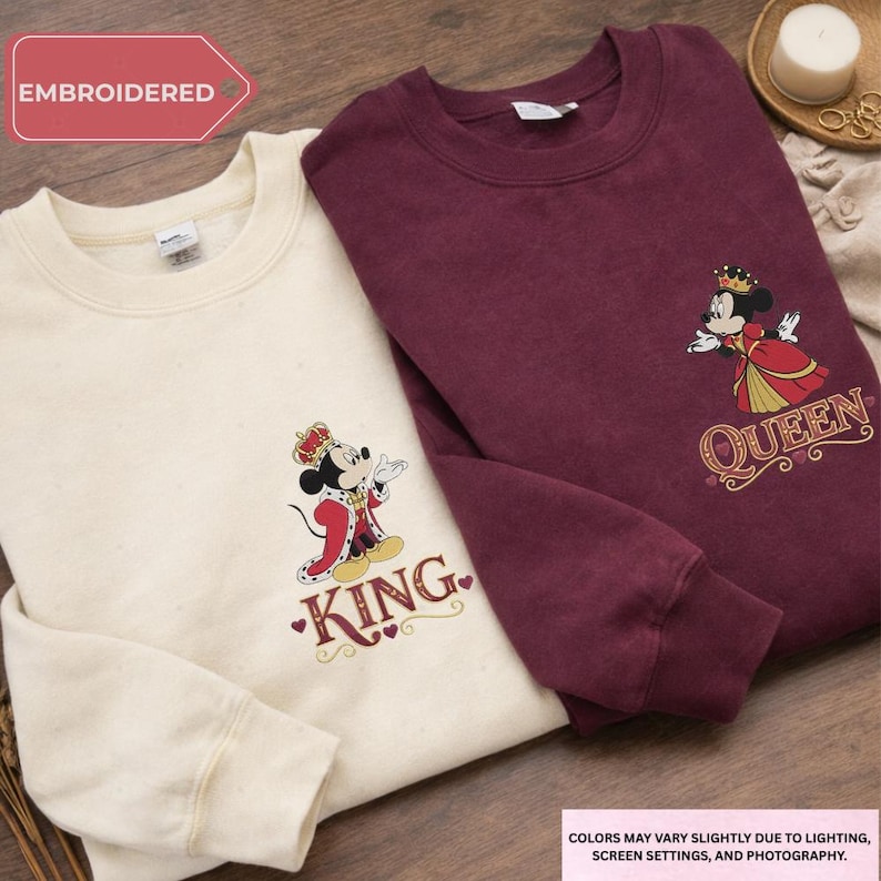 two sweatshirts with a Disney character design, one white and one burgundy, both with the text "King" printed on them.