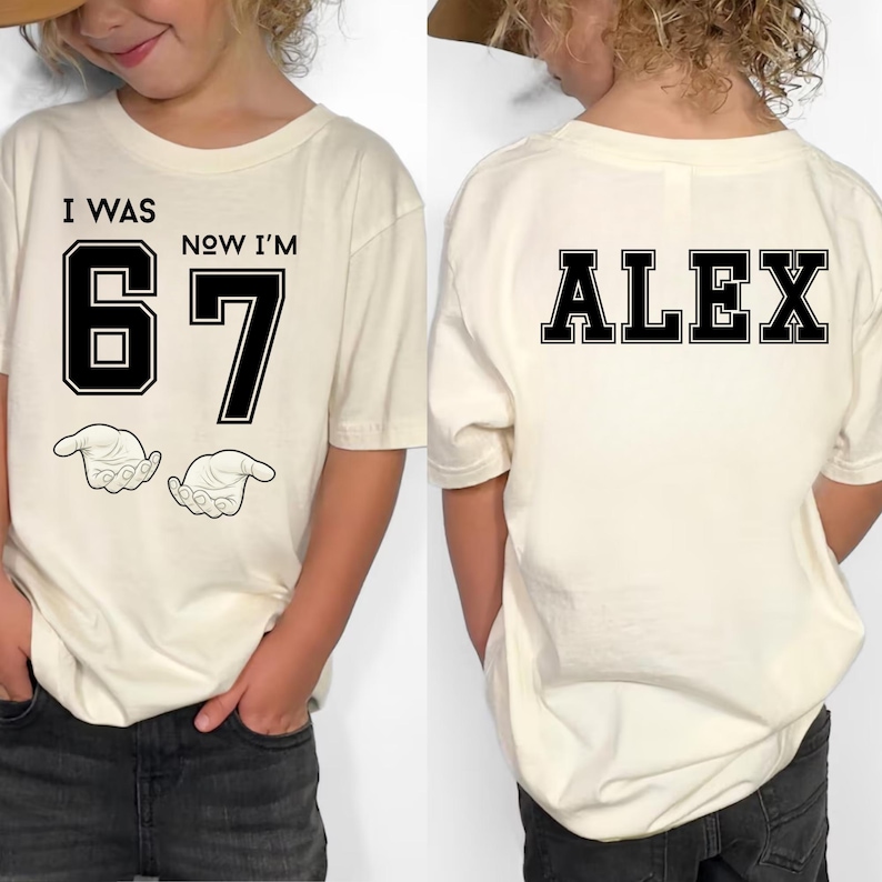 A person wearing a white t-shirt with the text "I WAS 67 NOW I'M ALEX" printed on it.