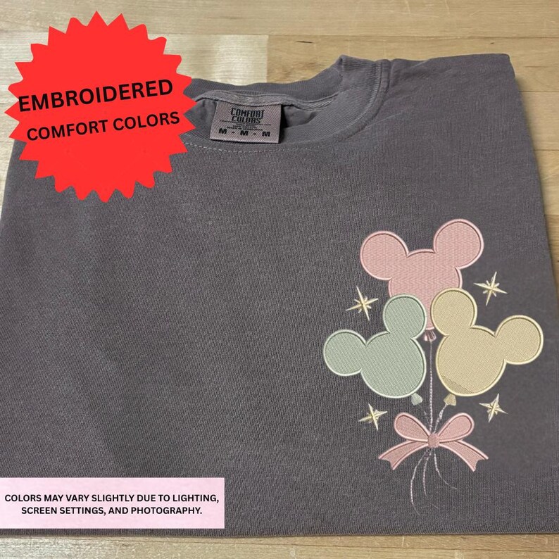 a gray t-shirt with a colorful Mickey Mouse design on the front.