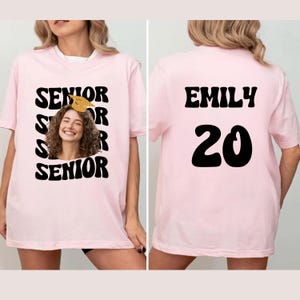 a woman wearing a pink t - shirt that says, senior senior senior senior senior