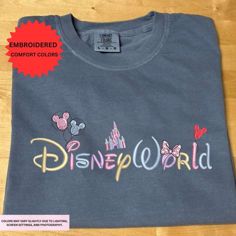 a gray t-shirt with the Disney World logo embroidered on it.