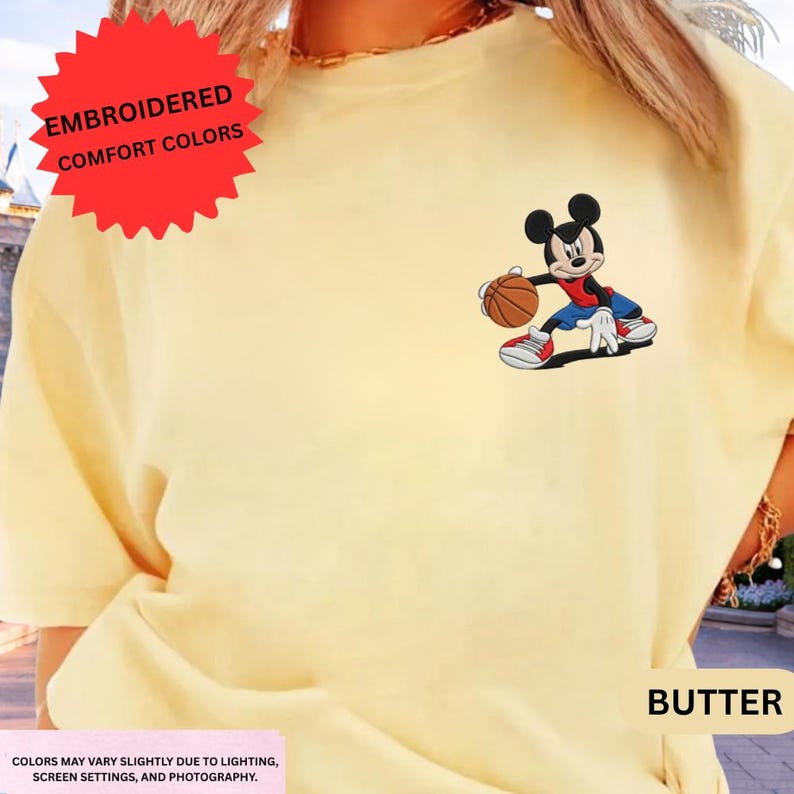 The image is a close-up of a person wearing a yellow t-shirt with a cartoon character of Mickey Mouse holding a basketball.