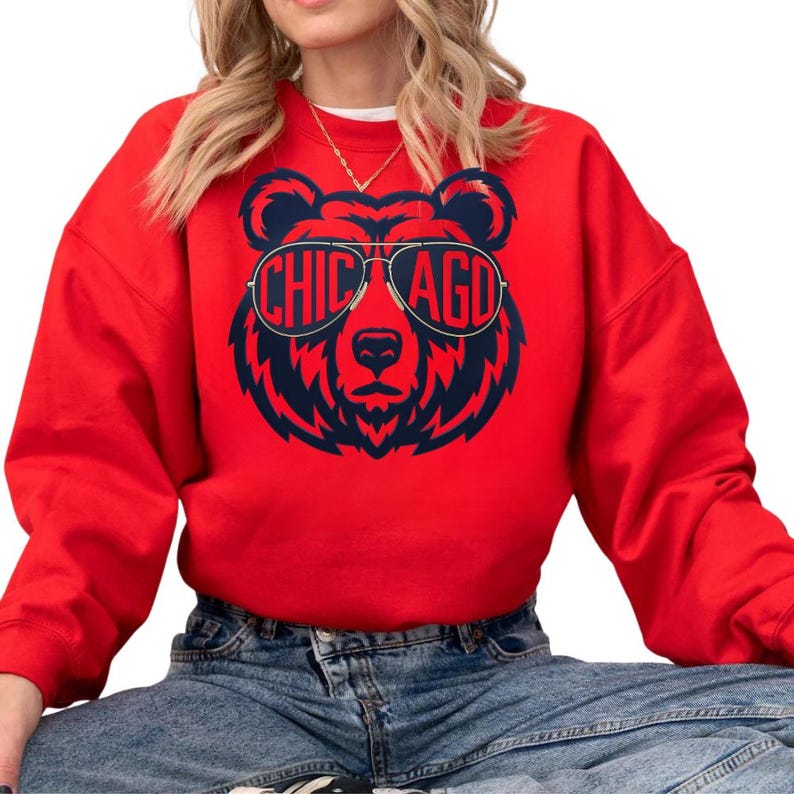 A woman wearing a red sweatshirt with a graphic of a bear wearing sunglasses and the text "CHICAGO" printed on it.