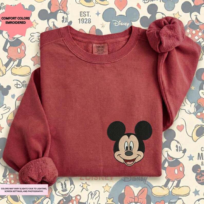 a red long-sleeved shirt with a Mickey Mouse embroidered logo on the front.