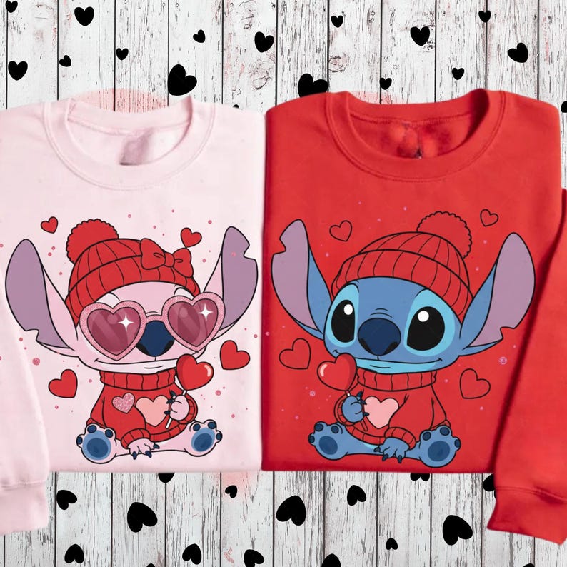 two sweatshirts with the same cartoon character design, one pink and one red.