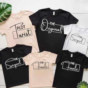 May include: A collection of t-shirts in various colors, including black, white, and beige. Each shirt features a unique text design in a minimalist style. The phrases include "Plot Twist", "The Original", "The Sequel", and "The Finale".