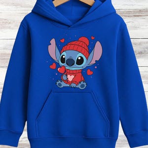 A blue hoodie with a cartoon image of a blue-skinned character wearing a red hat and holding a heart.