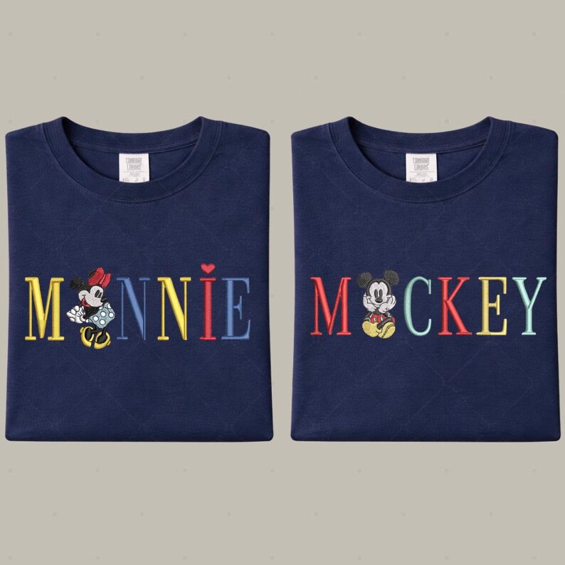 two blue t-shirts with the word "Minnie" and " Mickey" printed on them, along with illustrations of Minnie Mouse and Mickey Mouse.