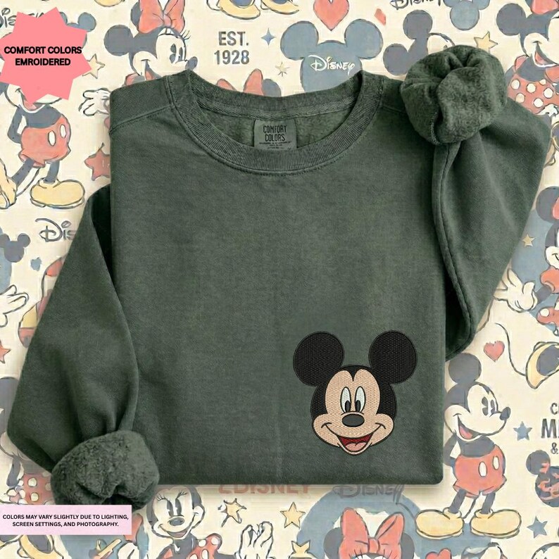 a green long-sleeved shirt with a Mickey Mouse embroidered logo on the front.