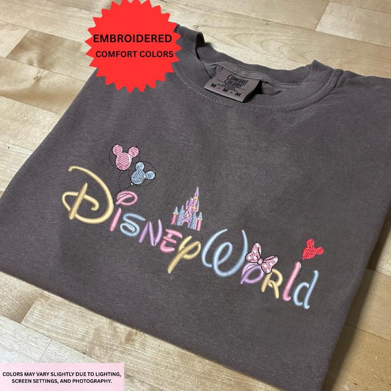 a gray t-shirt with the Disney World logo embroidered on it.