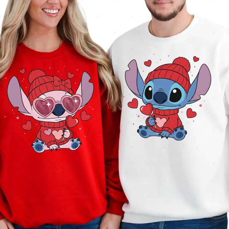 A woman wearing a red sweater with a cartoon character and a man wearing a white sweater with a cartoon character.