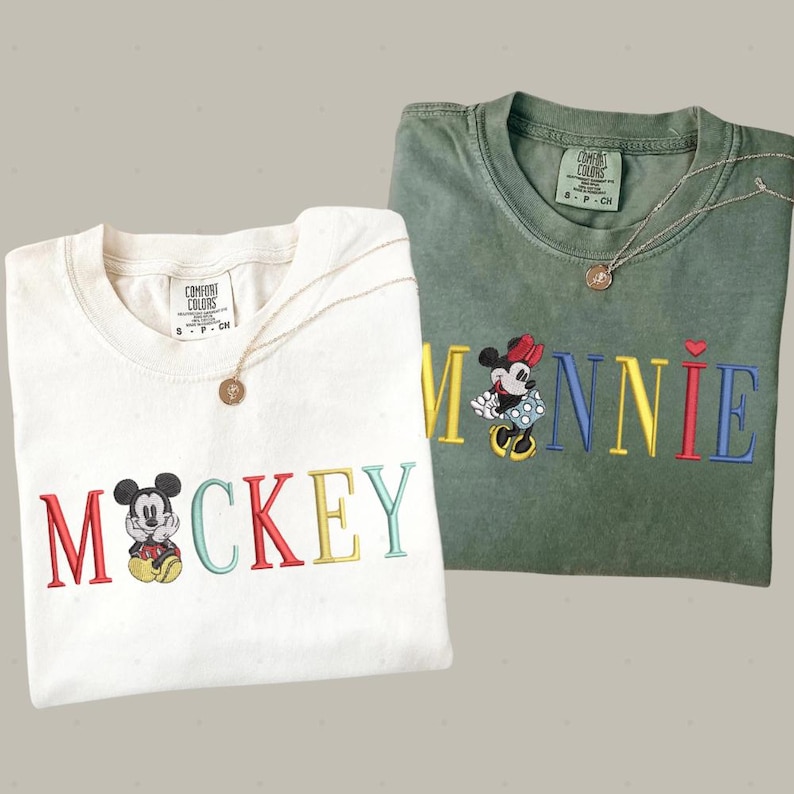 two t-shirts with the word "MICKEY" printed on them, along with images of Mickey Mouse.