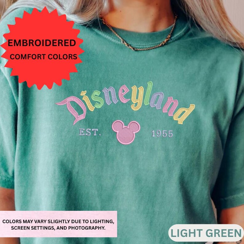 The image is an embroidered t-shirt with the text "Disneyland EST. 1955" and a Mickey Mouse logo. The colors of the t-shirt are green.