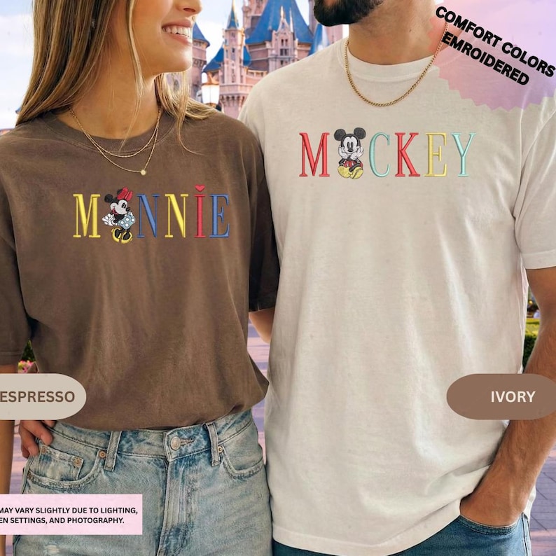 A woman wearing a brown t-shirt with the word "Minnie" and a man wearing a white t-shirt with the word " Mickey" printed on them, standing together in front of a castle.