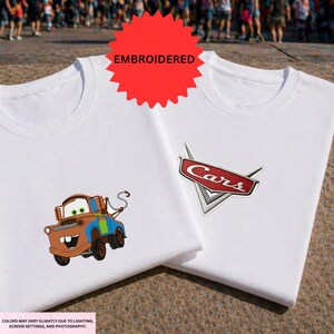 two white t-shirts with a character from the Cars movie printed on them.
