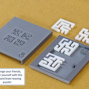 May include: A gray puzzle box with a white interlocking puzzle piece inside. The puzzle box has a gray lid with the words "锯齿" and "59" printed on it. The puzzle pieces are shaped like a maze. The text "Challenge your friends, kids, or yourself with this sleek and brain-teasing puzzle!" is printed below the image.