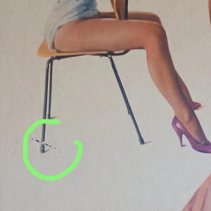 May include: Vintage poster art featuring a woman in a light blue top and red hat, seated on a wooden chair with black legs. The image has a retro aesthetic, with a focus on the woman's pose and attire.