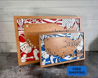 May include: Two rectangular wooden framed wall art pieces featuring a layered design with a light brown wooden map of the United States overlaid on a baseball-themed background. The larger piece has a red background, while the smaller has a blue one.