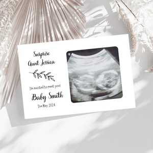 May include: A white card with black text announcing a pregnancy to Aunt Jessica. The card includes a black and white ultrasound image and the text "Surprise Aunt Jessica I'm excited to meet you! Baby Smith Due May 2024".