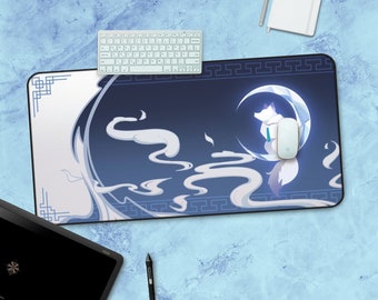 May include: A blue and white mouse pad with a white fox sitting on a crescent moon. The moon is glowing and there are white clouds around it. The mouse pad has a white border with a repeating pattern.