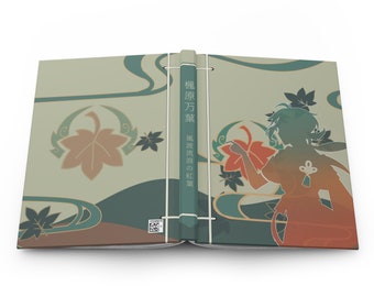 May include: A closed book with a green, brown, and orange cover. The cover features a stylized maple leaf design and the text "楓原万葉 楓の旅路の紅葉".