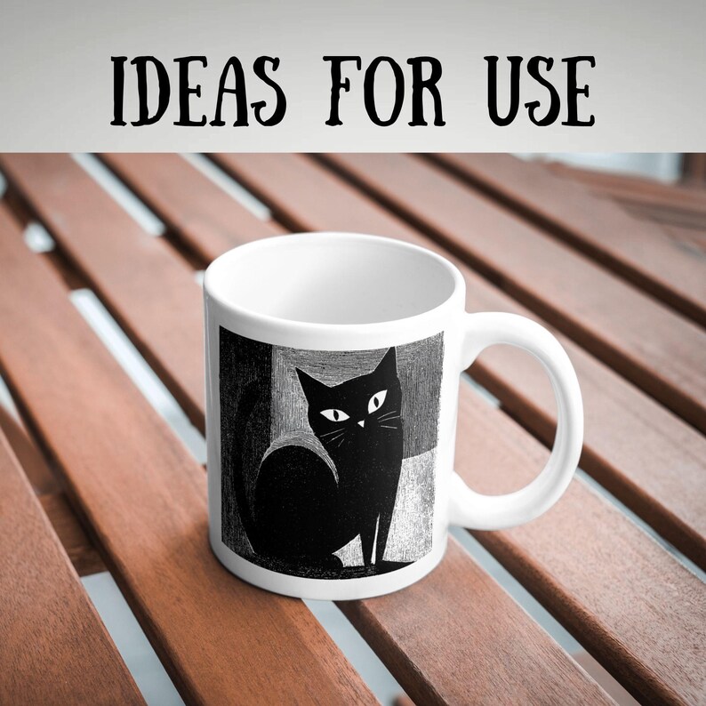 May include: White ceramic mug featuring a black cat illustration with white eyes and whiskers. The mug has a curved handle and the text "IDEAS FOR USE" in black. The cat design is set against a geometric background.