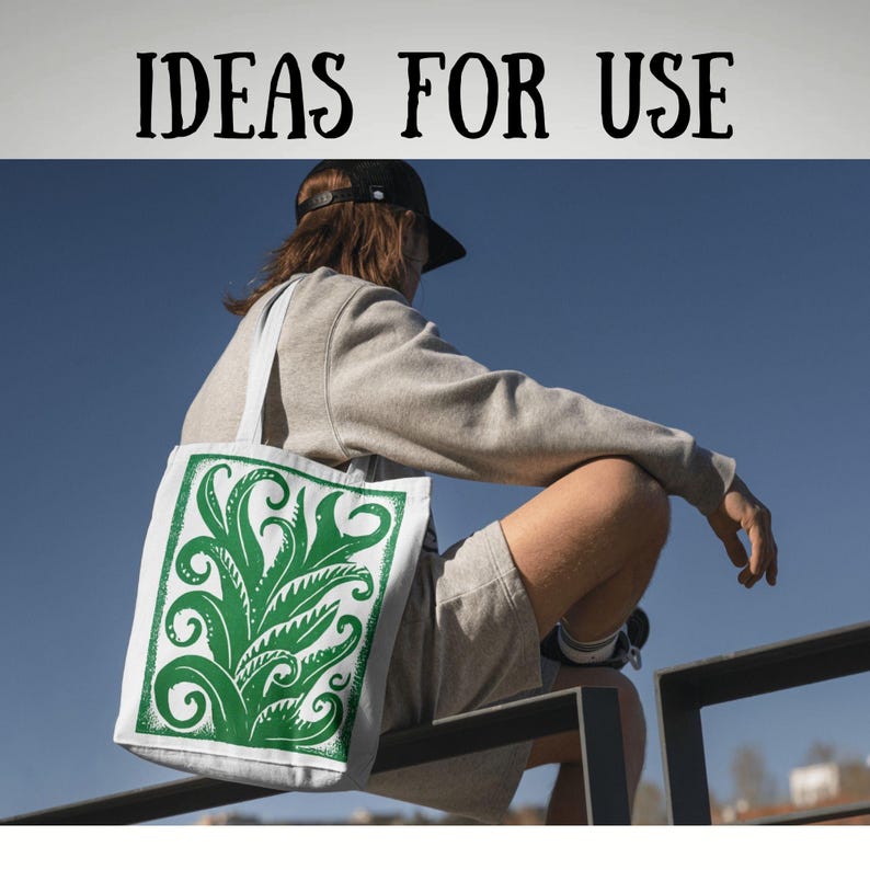 May include: A white tote bag with a green botanical design. The bag has a rectangular print of stylized leaves and swirls. The words "IDEAS FOR USE" are printed in black at the top of the image. The bag is carried by a person wearing a grey sweatshirt and shorts.