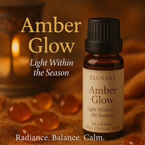 May include: A brown glass bottle of "Amber Glow" essential oil with a black cap. The label reads "Light Within the Season" and "Elunara Oils Collection." The image includes amber-coloured stones and text: "Radiance. Balance. Calm."
