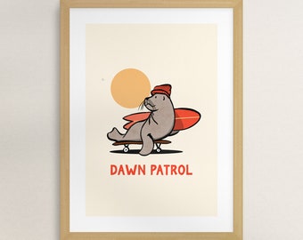 May include: A cartoon illustration of a seal wearing a red beanie and holding a surfboard while riding a skateboard. The background is a light yellow with a large orange sun. The text "DAWN PATROL" is printed below the seal.