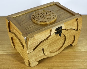Wooden casket made of natural oak with engraving on the lid for storing jewelry and memories, photos and various trinkets