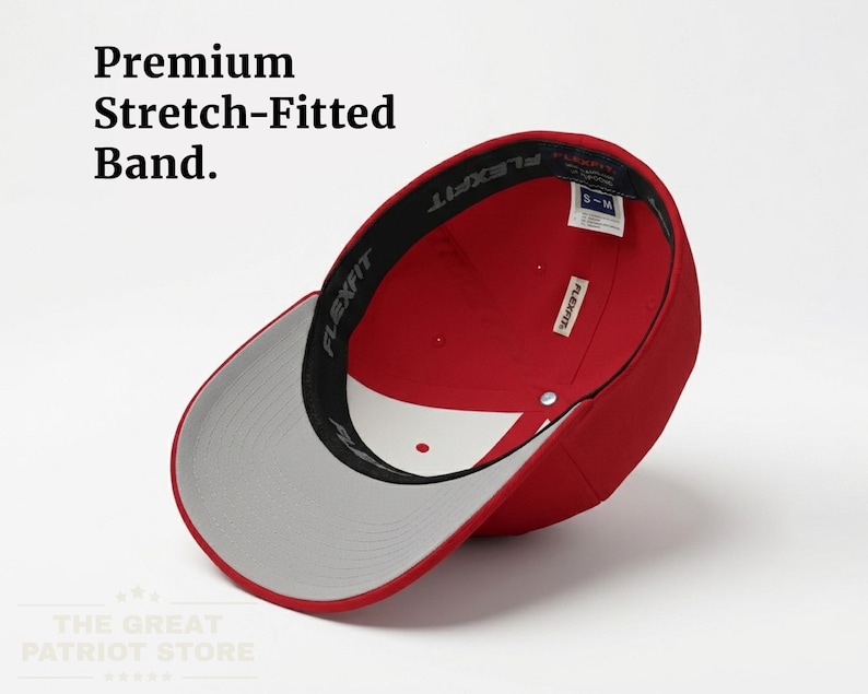 May include: A red baseball cap with a grey underside of the brim and a black interior sweatband featuring the text Flexfit. The cap includes a white interior panel and a size tag reading S-M. Text in the image reads Premium Stretch-Fitted Band.