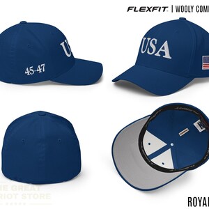 May include: A royal blue Flexfit wooly combed cap featuring the text USA embroidered in white on the front, the numbers 45-47 on the side, and a small American flag patch on the other side. The cap has a structured crown and a curved brim.