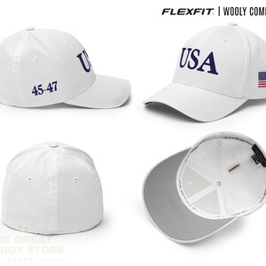 May include: A white Flexfit wooly combed cap featuring the text USA in blue on the front, the number 45-47 on the side, and a small American flag patch on the other side. The cap is shown from multiple angles, including the interior lining.