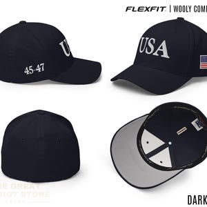 May include: A dark navy Flexfit wooly combed cap featuring the text USA embroidered on the front, the numbers 45-47 on the side, and a small American flag patch on the other side. The cap has a structured crown and a curved brim.
