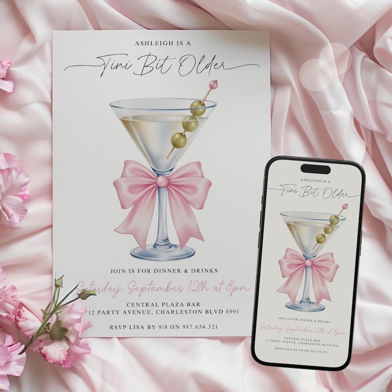 May include: A printed invitation and a smartphone displaying the same design. The invitation features a martini glass with olives, a pink bow, and the text "Ashleigh is a Vini Bit Older". The phone shows the same design.