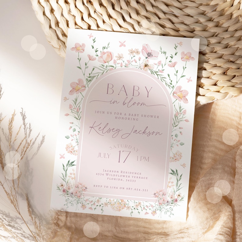 May include: A pink and white baby shower invitation with a floral border and the text "Baby in Bloom" and "Kelsey Jackson". The invitation includes the date and time of the shower, the address, and the RSVP information.