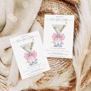 May include: Two invitation cards with a martini glass illustration. The martini glass has olives and a pink bow. The text on the card reads "Ashleigh is a Tini Bit Older" and details for a dinner and drinks event.