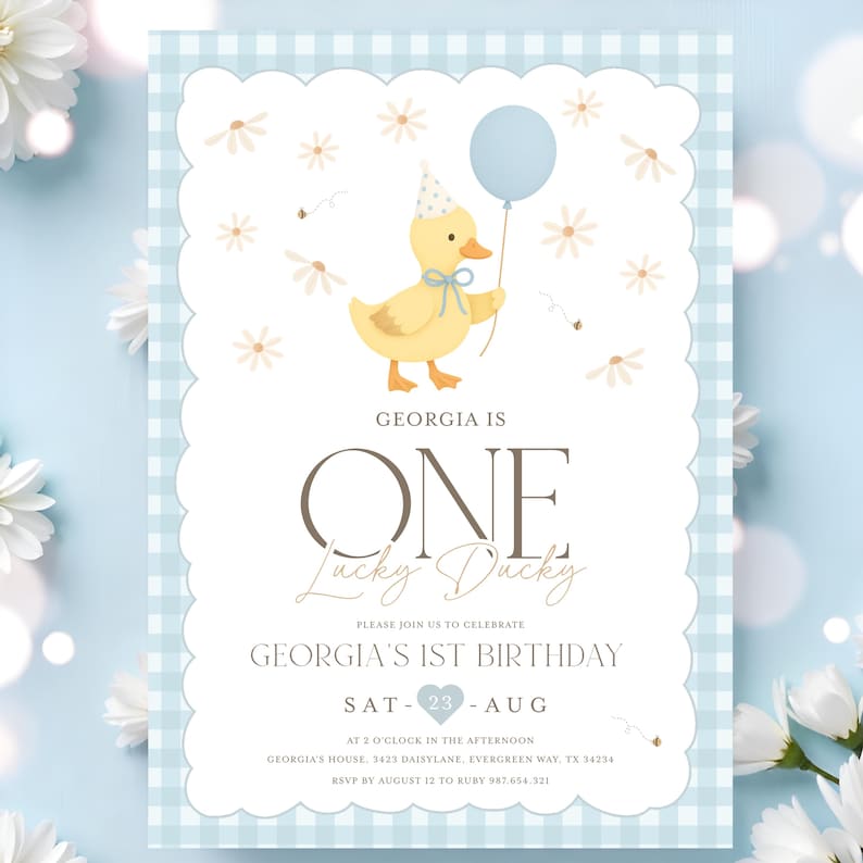 May include: A light blue and white gingham-patterned invitation with a scalloped edge. The invitation features a yellow duck holding a blue balloon, and the text "GEORGIA IS ONE Lucky Ducky" is displayed.