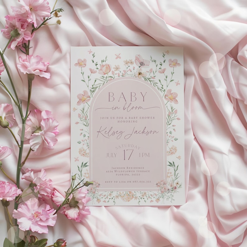 May include: A pink floral baby shower invitation with the text "Baby in Bloom" and the name "Kelsey Jackson". The invitation includes the date and time of the shower, as well as the address and RSVP information.