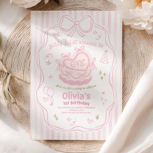 May include: Pink and white striped birthday invitation with a decorative border. The invitation features the text "girls just wanna be one" and "Olivia's 1st birthday". The design includes a cake, balloons, and stars.