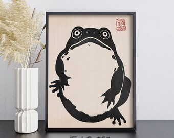 May include: Black and white illustration of a frog in a black frame with a red stamp in the top right corner. The text "Timber Prints GB" is printed below the frame.