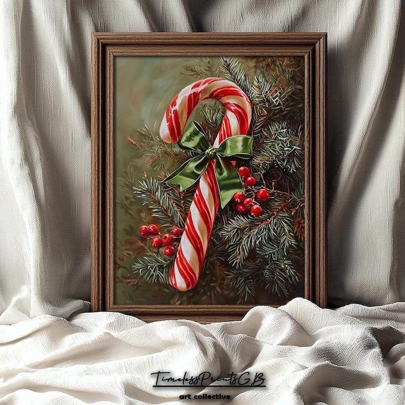 May include: A framed print depicting a candy cane with red and white stripes, a green bow, and red berries, set against evergreen branches. The frame is a warm brown colour. A festive Christmas-themed artwork.