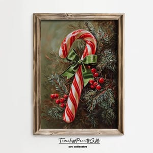 May include: A framed print depicting a candy cane with red and white stripes, a green bow, and red berries, set against evergreen branches. The artwork is signed "TimelessPrintsGB art collective". The image evokes a festive Christmas theme.